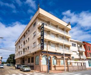 a building on the corner of a street at LOS NAREJOS Hotel in Los Alcázares