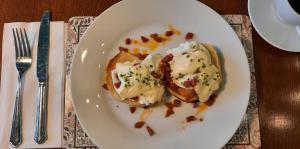 a white plate with two pieces of food on a table at Rocklea Guest House in Windermere