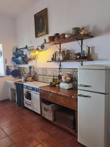 a kitchen with a stove and a white refrigerator at al numero zero in Lipari