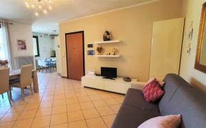 sala de estar con sofá y TV en APARTMENT A CASA DI LA' - Regarda Travel en Lazise