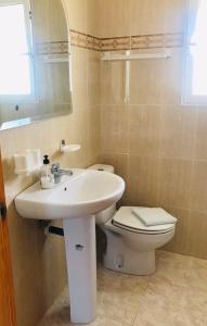 a bathroom with a sink and a toilet at The House in Casas Devesa