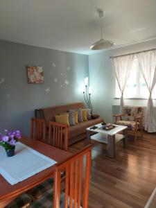 a living room with a couch and a table at Apartment Rosie in Smoljanac