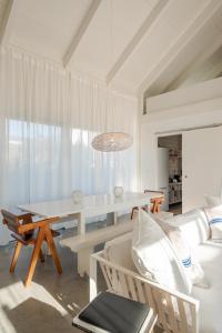 a living room with a table and a couch at Precious Cabin in Comporta in Comporta +24 photos