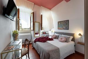フィレンツェにあるPitti - Flo Apartmentsの小さなベッドルーム(ベッド1台、テレビ付)