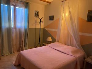 a hotel room with a bed and a window at B&B Macchia Verdata avec piscine chauffée in Monacia-dʼAullène