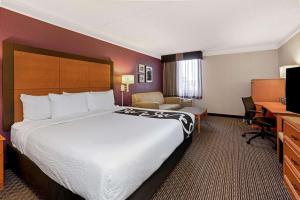 a hotel room with a large bed and a desk at La Quinta by Wyndham Tacoma - Seattle in Tacoma
