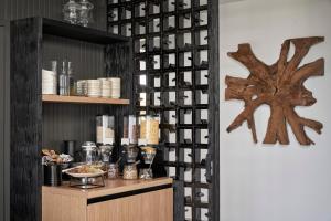 a dining room with a wall of wine bottles at Loizos Stylish Residences in Fira