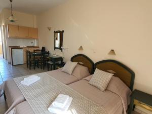 A bed or beds in a room at Zannis Hotel