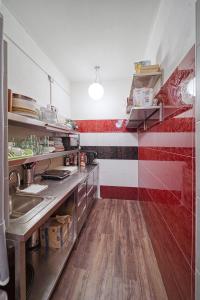a kitchen with red and white stripes on the wall at Hostel Orange in Prague