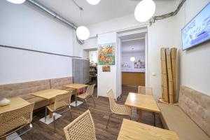 a dining room with wooden tables and chairs at Hostel Orange in Prague