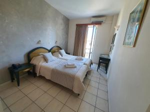 A bed or beds in a room at Zannis Hotel