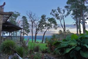 a garden with a view of the water at Gorgeous villa 10 acre of land in Menzies Creek
