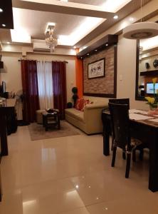 a living room with a couch and a table at Sarasota Residential Resort cluster 4 Unit 6C & 6L by Manny Newport Blvd, across NAIA T3 & near Resorts World Manila, Pasay City in Manila