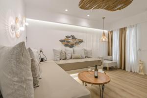 a living room with a couch and a table at Villa Adriana Hotel in Agios Prokopios