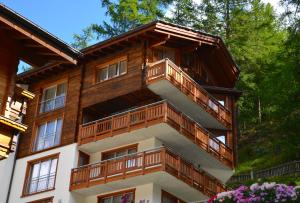 a building with balconies on the side of it at Jägerhof Serviced Apartements in Zermatt