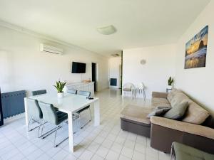 a living room with a white table and a couch at Al Mare Apartament in Fano