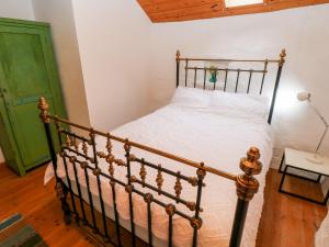 a bedroom with a bed and a green door at Ty Mellen in Newport Pembrokeshire