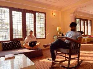 a man and a woman sitting in a living room at Together Shimla in Shimla