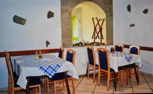 a restaurant with two tables with blue and white table cloth at Pension Knafel in Žirovnica