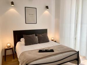 a bedroom with a large bed with a tray on it at LES HALLES 2 - Central in Mont-de-Marsan