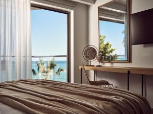 A bed or beds in a room at Windmill Bay Hotel