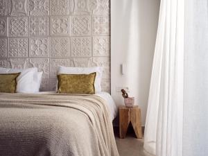 A bed or beds in a room at Windmill Bay Hotel