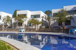 a house with a swimming pool in front of a building at VILLA MANAVA in Llafranc