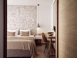 A bed or beds in a room at Windmill Bay Hotel