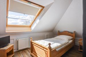 a bedroom with a wooden bed and a window at Landhaus Schwerin in Schwerin