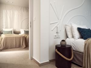 A bed or beds in a room at Windmill Bay Hotel