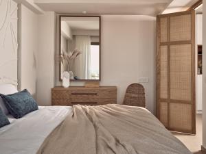 A bed or beds in a room at Windmill Bay Hotel