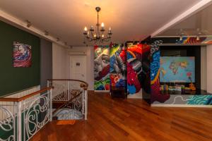a room with colorful paintings on the walls at Wanderlust boutique hostel in Almaty