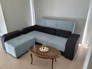 a living room with a couch and a table at Cantinho do Sonho in Maia