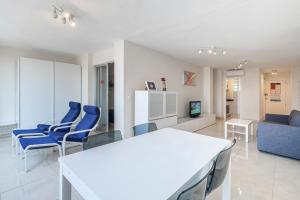 ベニドルムにあるLidersol 11-D Apartment Levante Areaのリビングルーム(青い椅子、白いテーブル付)