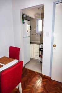 a kitchen with a red chair and a white refrigerator at Palermo 2 in Buenos Aires