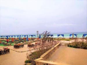 a beach with tables and chairs and the ocean at Royal Sea View in Alexandria