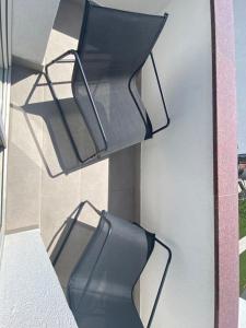 a balcony with two black chairs on a building at Villa Mara in Pula