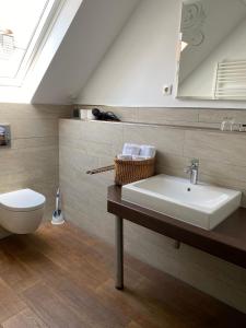 a bathroom with a sink and a toilet at Hotel Alt Westerholt in Herten