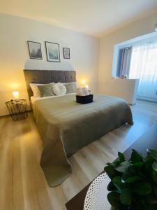 a bedroom with a large bed with a large headboard at Mara apartment in Băile Herculane