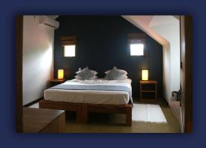 Postel nebo postele na pokoji v ubytování L'Hirondelle Self Catering Guest House