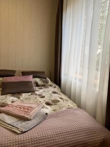 1 dormitorio con 1 cama y ventana en Rotušė, en Trakai