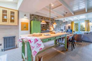 a kitchen with a table and chairs in a room at Secret Cottage in St Ives
