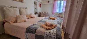 a bedroom with a bed with a towel on it at App Maria 3 in Zambratija