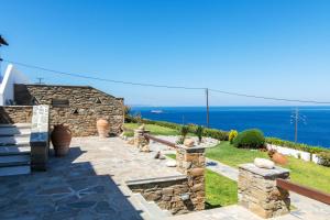 a stone house with a view of the ocean at Sail Inn in Agios Romanos