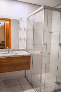 a bathroom with a shower and a sink at Ecologic Ville Resort - Oficial in Caldas Novas