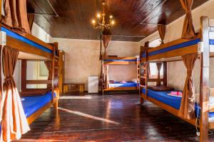 a room with three bunk beds and a chandelier at Montenegro Hostel 4U in Kotor
