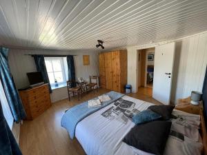 a bedroom with a large bed with a wooden ceiling at Le Domaine De Malchamps in Spa