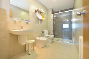 a bathroom with a sink and a toilet and a shower at Hotel Montemar *** Superior in O Grove +52 photos