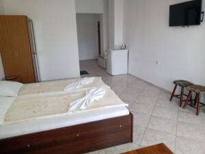 a bedroom with a bed and a tv in a room at Guest House Diamant in Sozopol