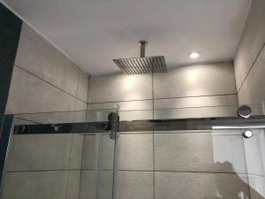 a shower with a glass door and a ceiling at Blue Escape (Beach Seafront) in Larnaka +23 photos